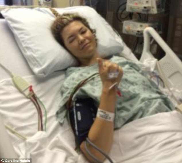 Thumbs up! Caroline Heinle, 31, underwent 'miracle' surgery to correct her spine which had a 46-degree curve 